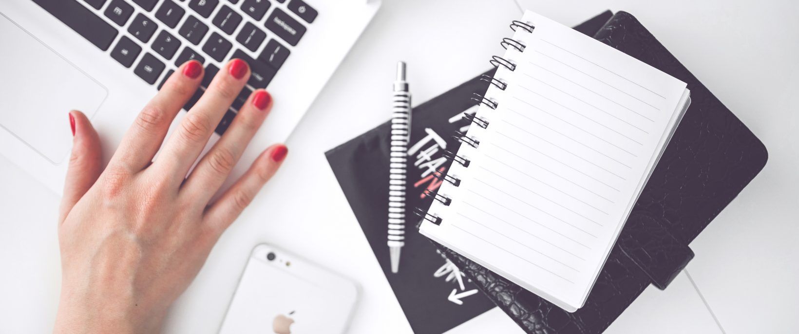 cropped woman hand smartphone desk